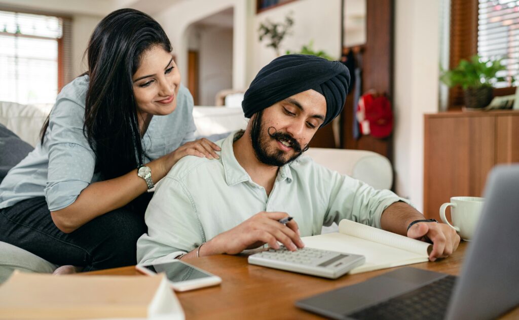 Couple calmly reviewing finances at home, symbolizing peace of mind through planning.”